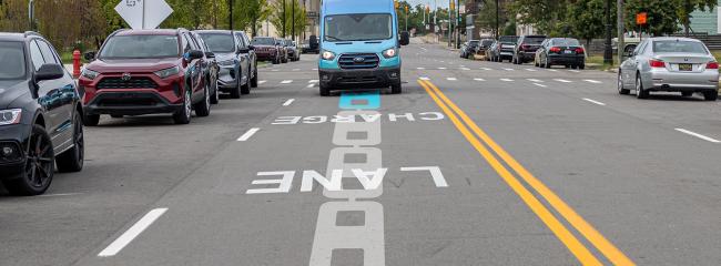 Michigan’s 14th Street pilot project features two lanes of inductive charging coils on an active four-lane roadway; the coil images in the road surface are illustrations. (Image courtesy of Electreon)